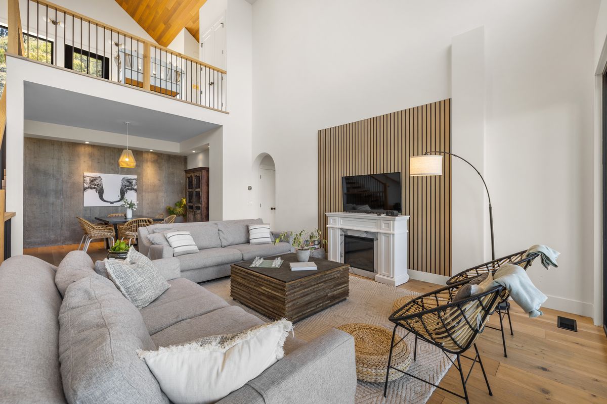Great room after — light oak slat feature wall behind fireplace and TV
