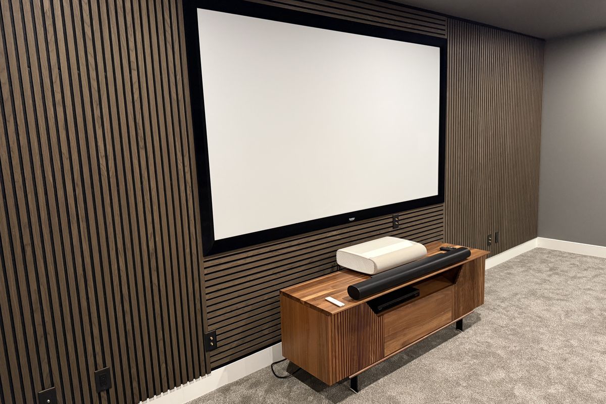 Theatre wall after — full wood slat surround