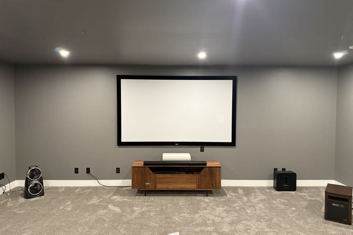 Theatre wall before — plain painted drywall