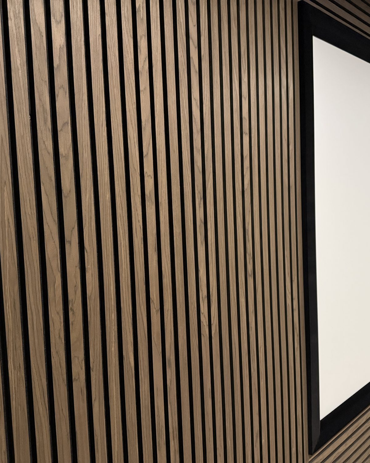 Wood slat acoustic wall in a home theatre, Kelowna